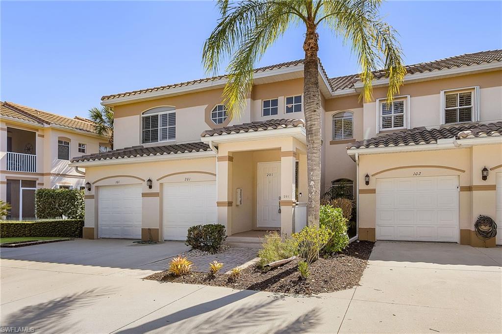 Mediterranean / spanish-style house with concrete driveway, an attached garage, and stucco siding