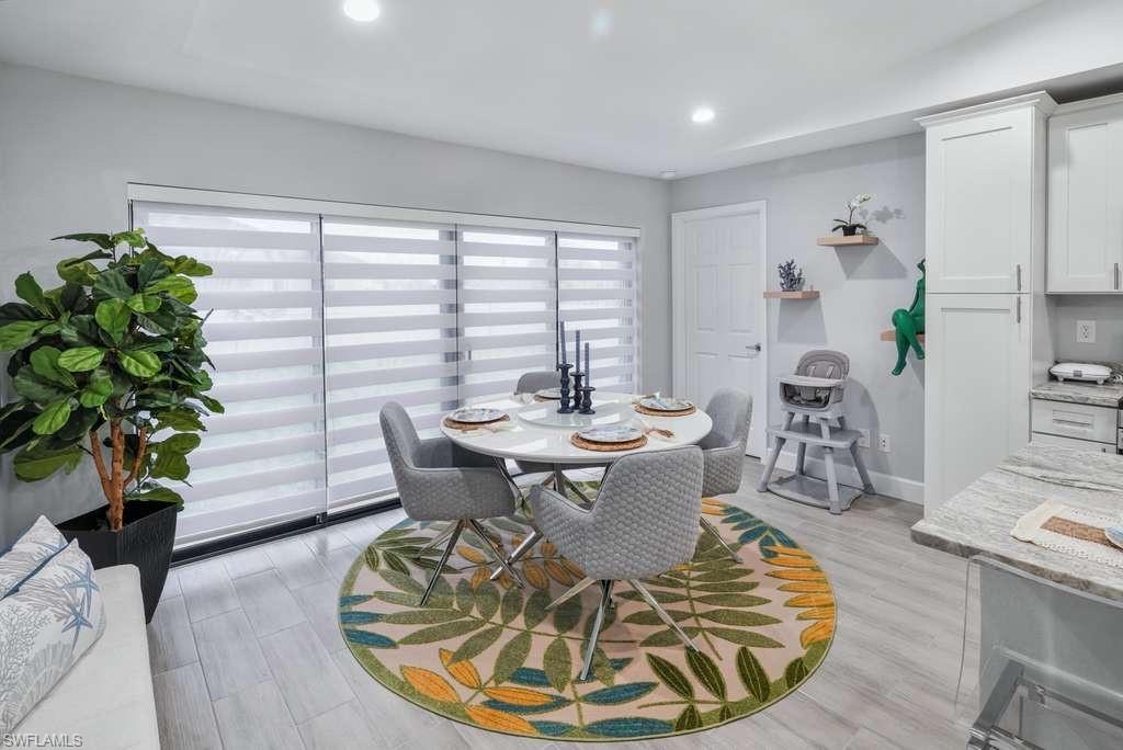 Dining space with light wood-type flooring and recessed lighting