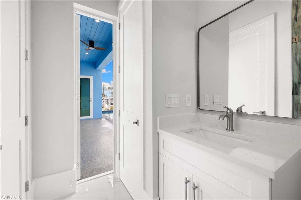 Bathroom with vanity and ceiling fan