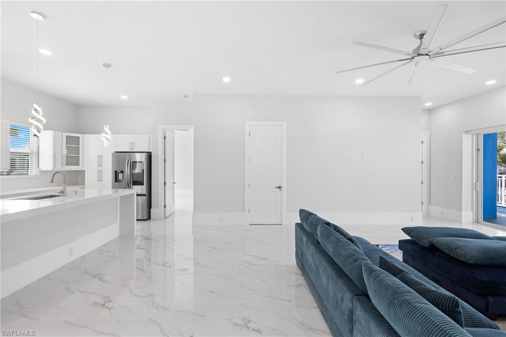 Living area featuring ceiling fan and recessed lighting