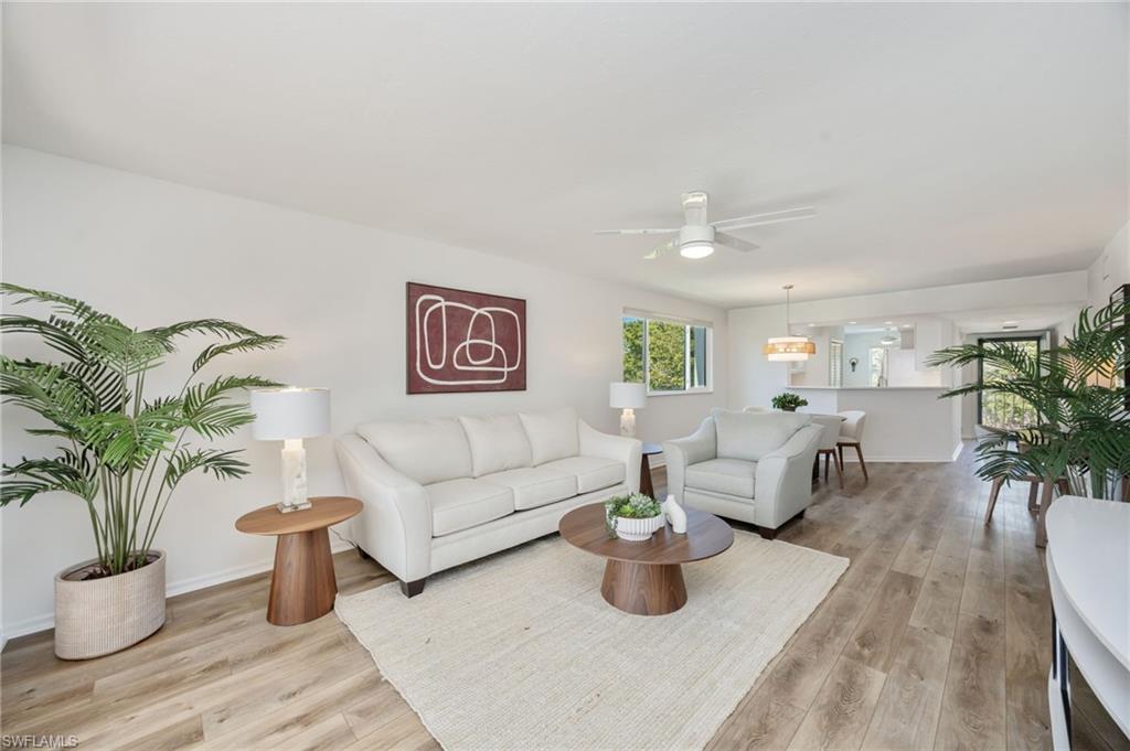 Living room with a ceiling fan and light wood finished floors