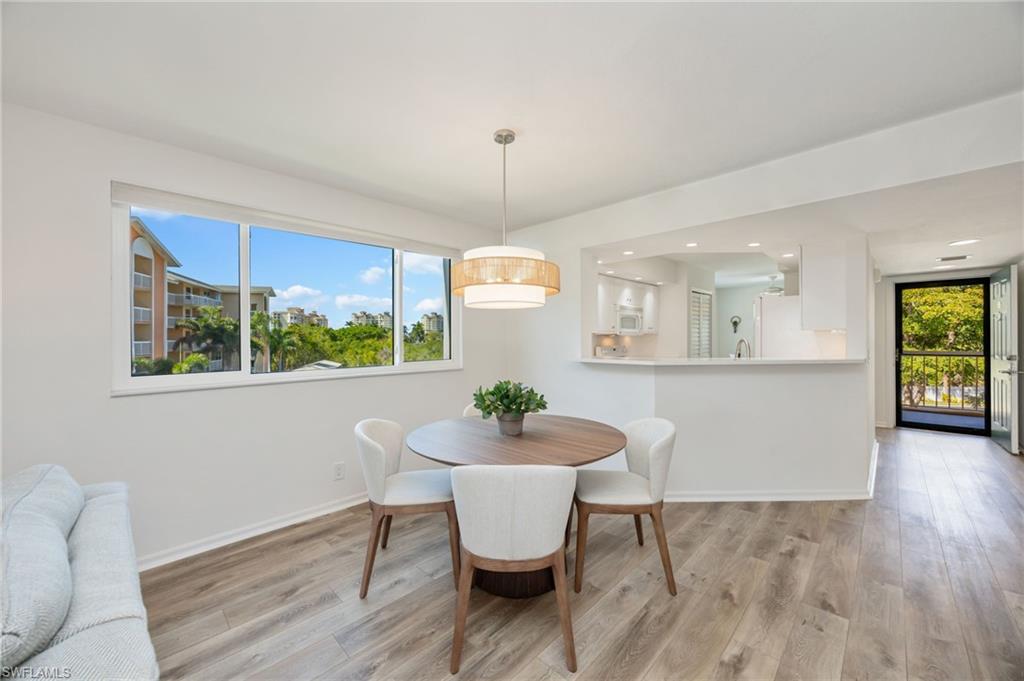 Dining area with wood finished floors and recessed lighting