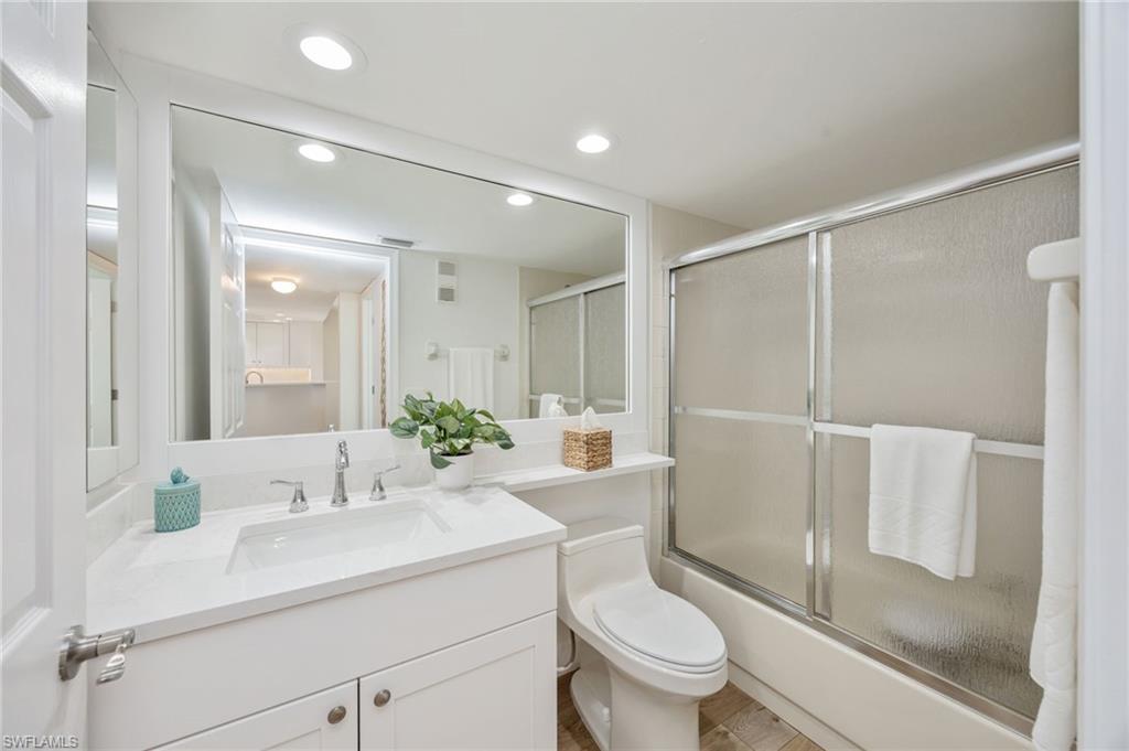 Guest Bathroom with vanity, enclosed tub / shower combo, and recessed lighting
