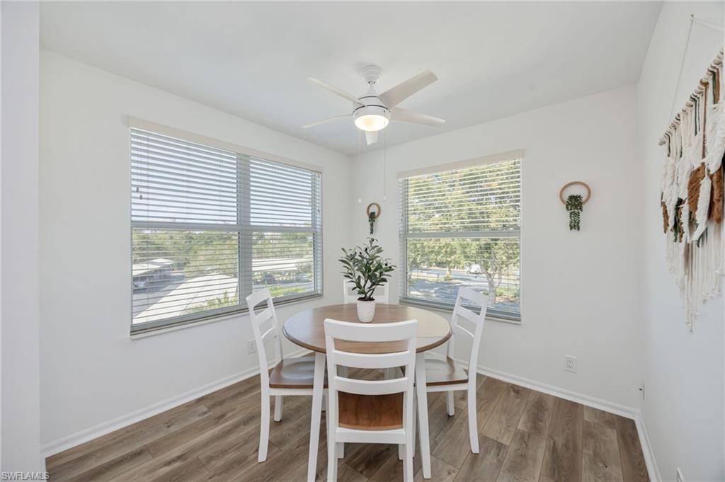 Dining area with light wood-style floors, a ceiling fan, and healthy amount of natural light