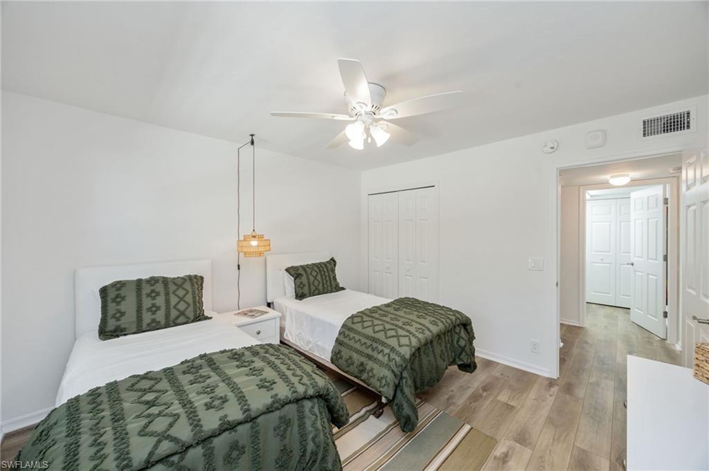 Bedroom featuring wood finished floors, ceiling fan, and a closet
