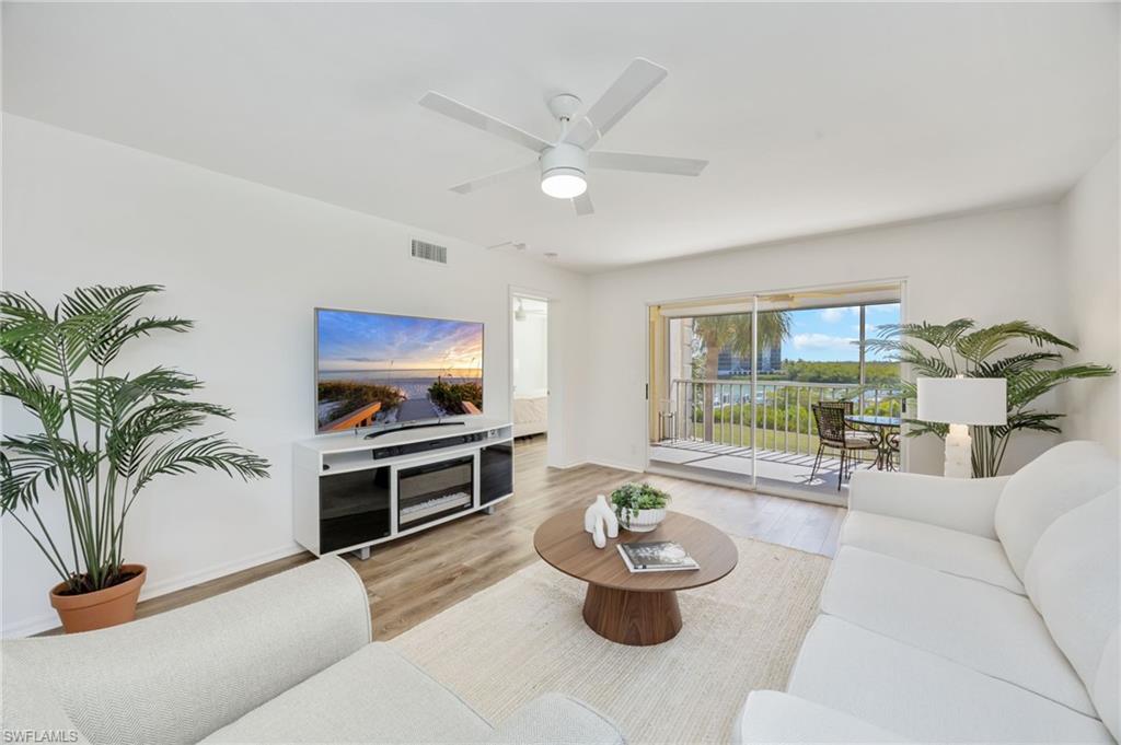 Living room with wood finished floors and a ceiling fan