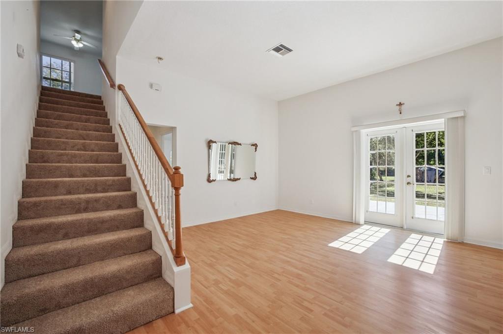 Staircase with French doors and wood laminate floors