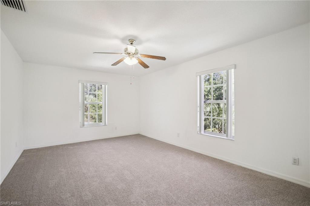 Carpeted bedroom 2 featuring healthy amount of natural light and a ceiling fan