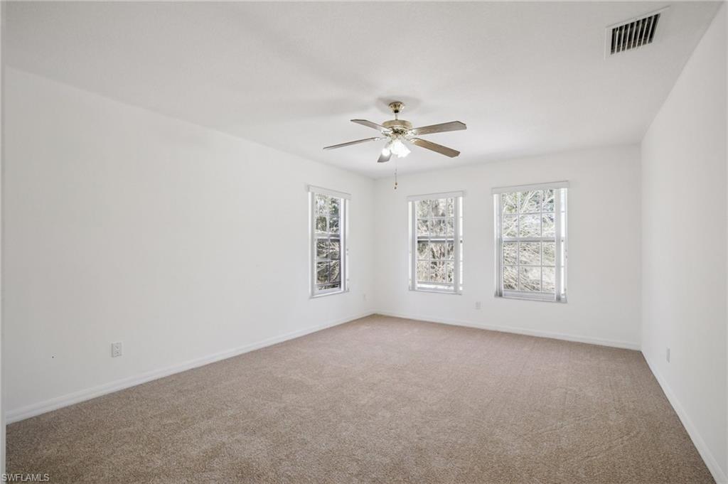 Bedroom 3 featuring healthy amount of natural light, light carpet, and ceiling fan