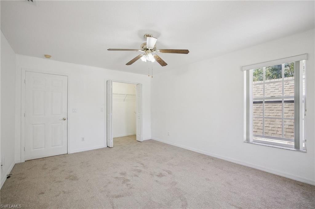 Other view of bedroom 3 with light carpet, ceiling fan, and a closet