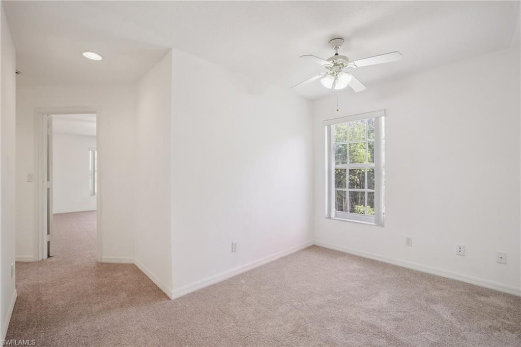 Bonus room featuring light-colored carpet and a ceiling fan