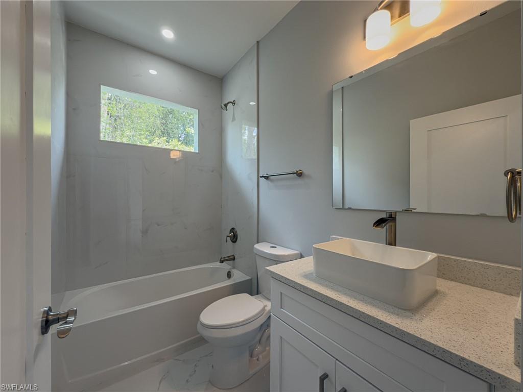 2nd Bathroom with recessed lighting, marble finish floor, toilet, shower / tub combination, and vanity