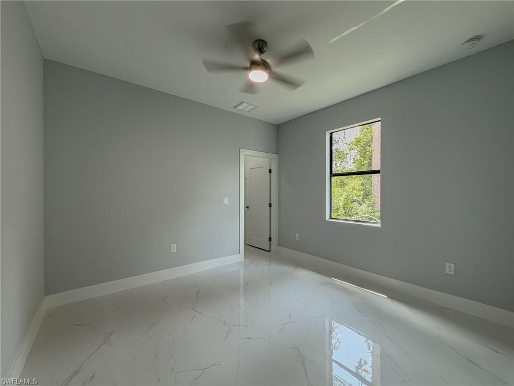 Room #2 with baseboards, visible vents, ceiling fan, and marble finish floor