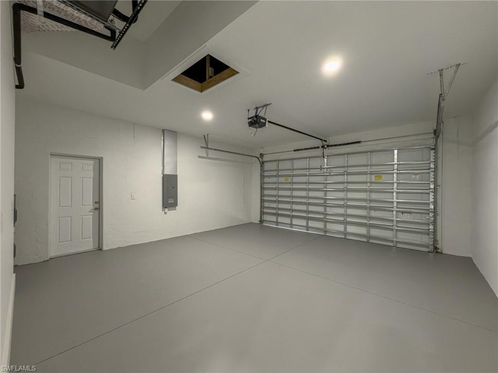 Garage with electric panel and a garage door opener