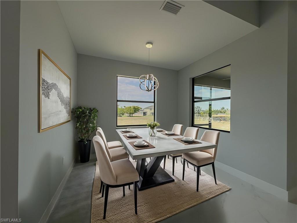 Dining space with a notable chandelier, baseboards, and visible vents