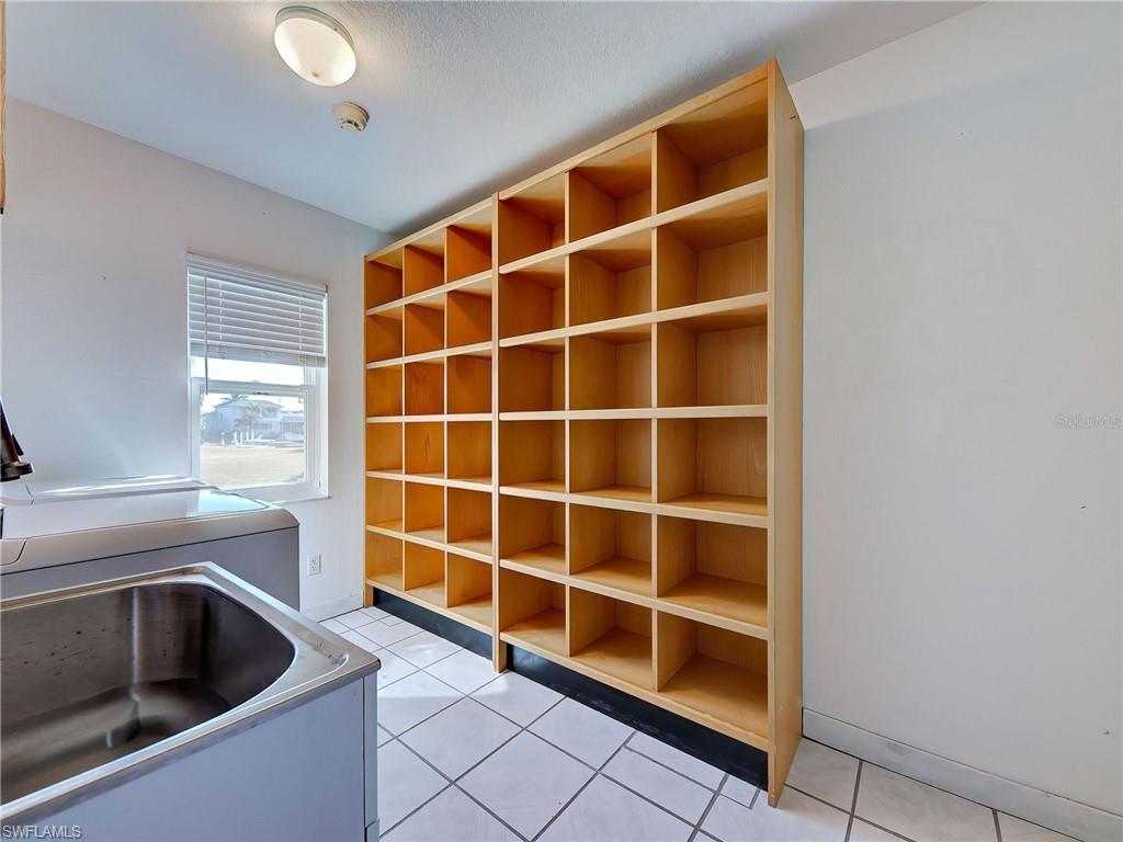 Mudroom with light tile patterned floors and washer / dryer