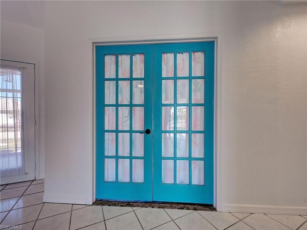 Doorway to outside with french doors and tile patterned flooring