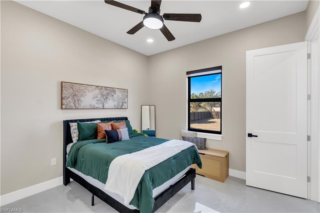 Bedroom with a ceiling fan and recessed lighting