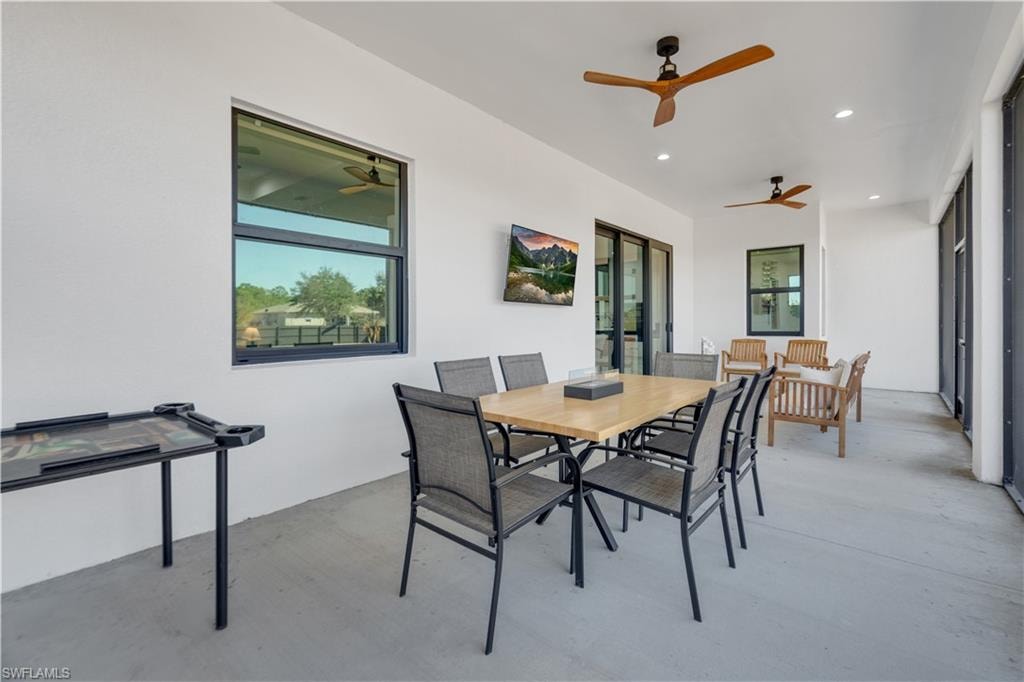 Dining space with finished concrete floors and recessed lighting