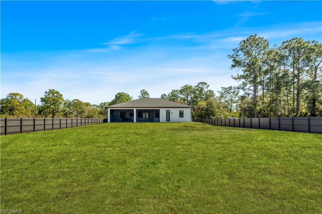 Fenced backyard with a sunroom