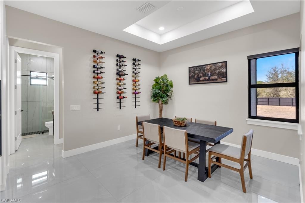Dining space with a raised ceiling and recessed lighting