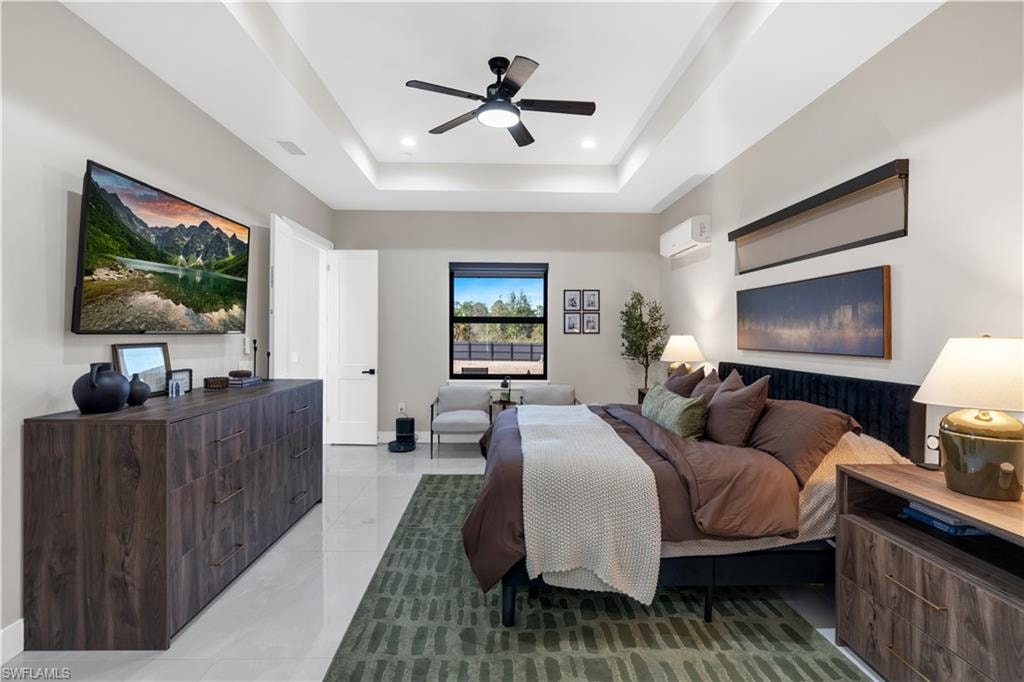 Bedroom featuring a ceiling fan, a raised ceiling, and recessed lighting