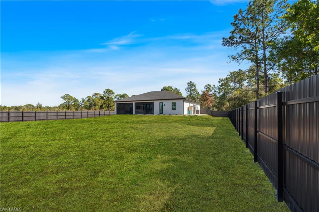 Fenced backyard with a sunroom