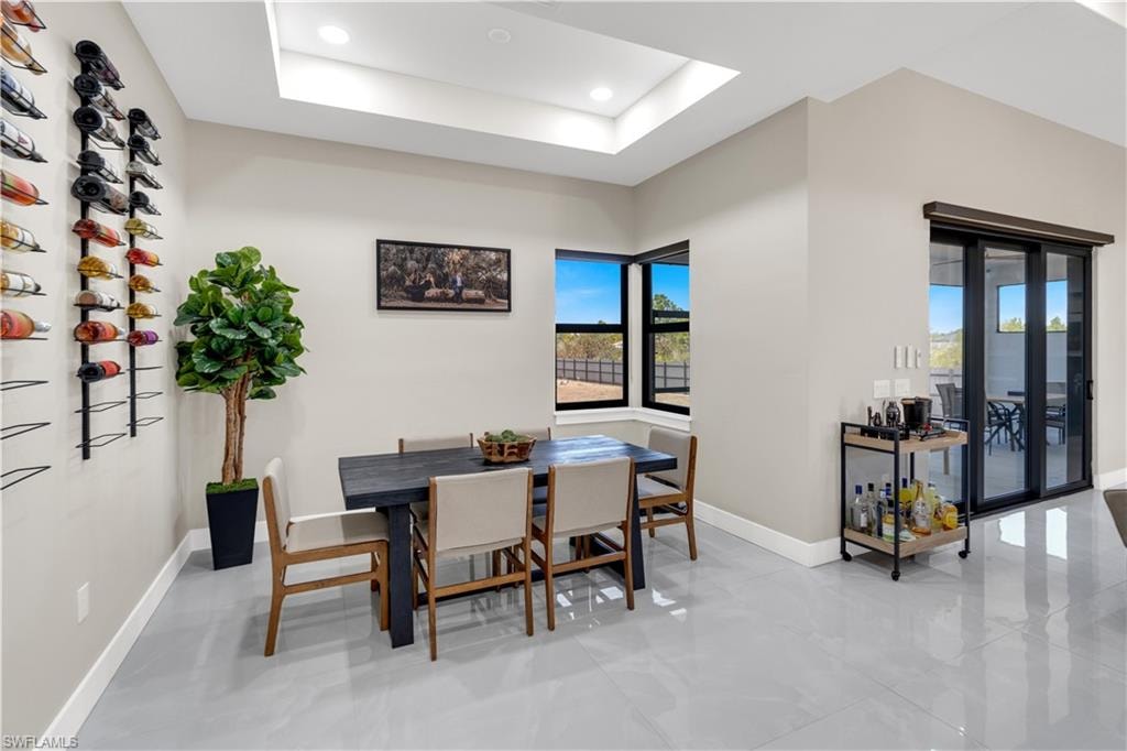 Dining area featuring a raised ceiling