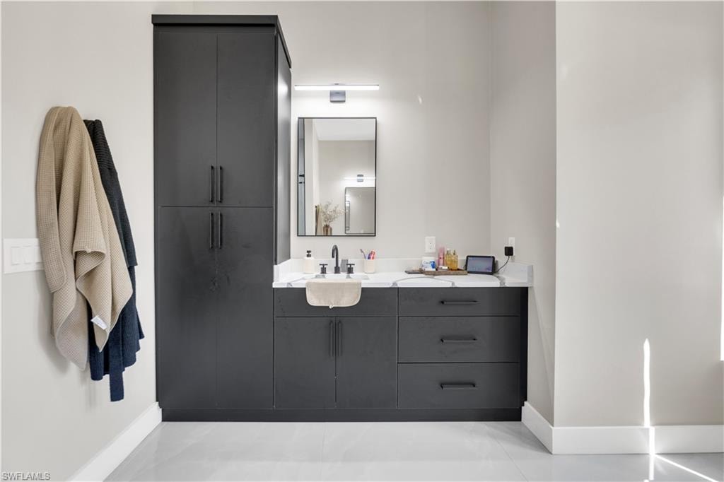 Bathroom with vanity and baseboards