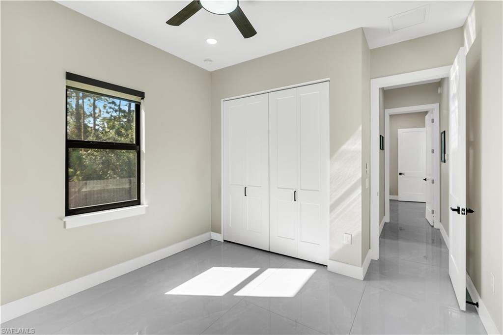 Unfurnished bedroom featuring a ceiling fan and a closet