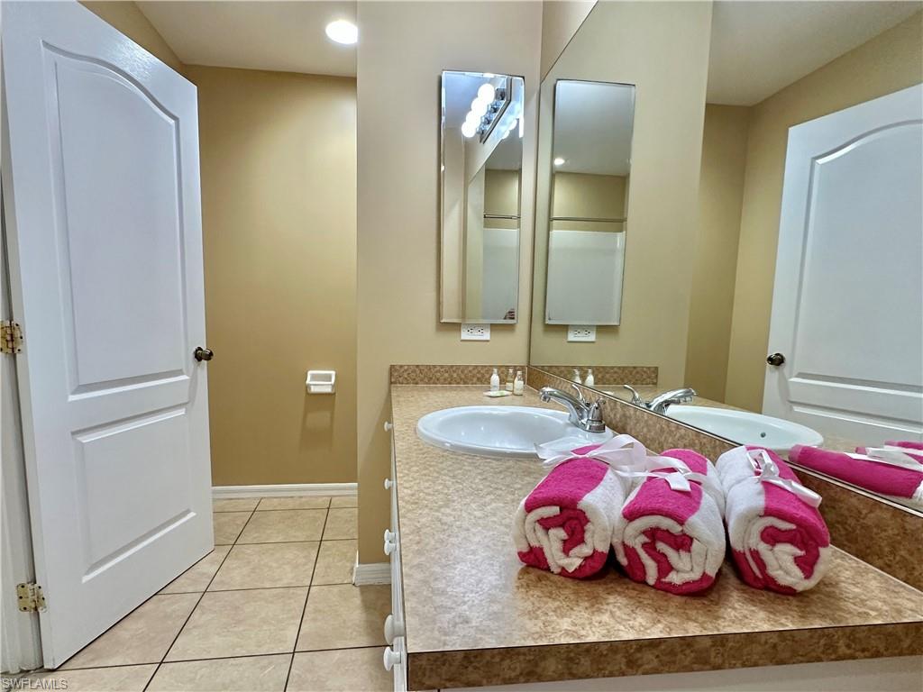 Primary Bath Mirrored Vanity with Med Cabinet and doorway to Toilet Closet