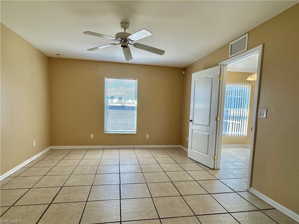 Primary Tiled Bedroom with New Lighted Fan