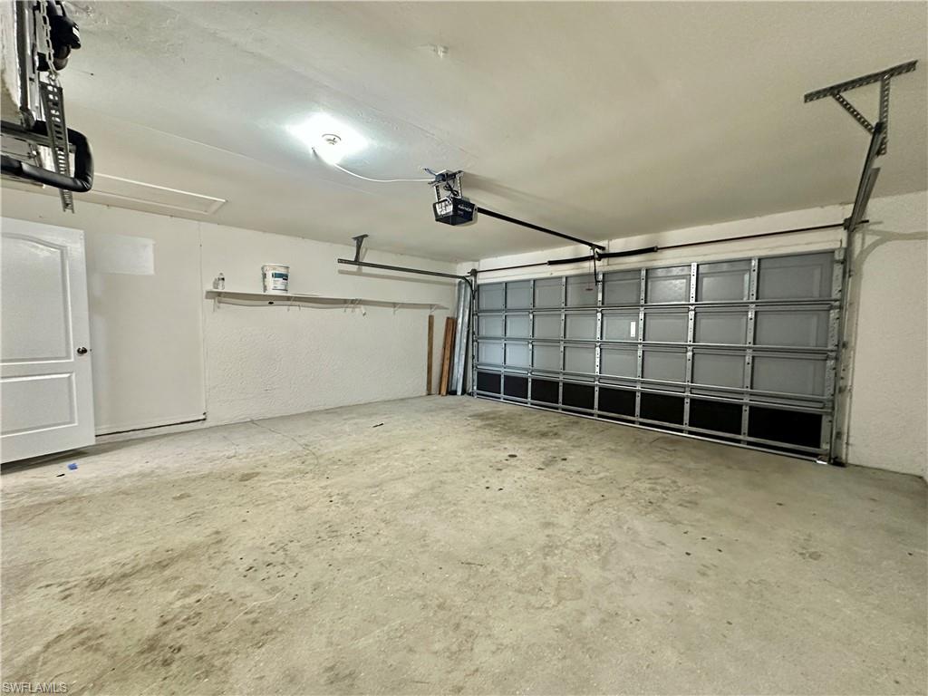 View of Two Car Garage with a new Water Heater.