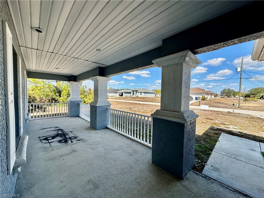 View of Front Lighted Porched Under Truss