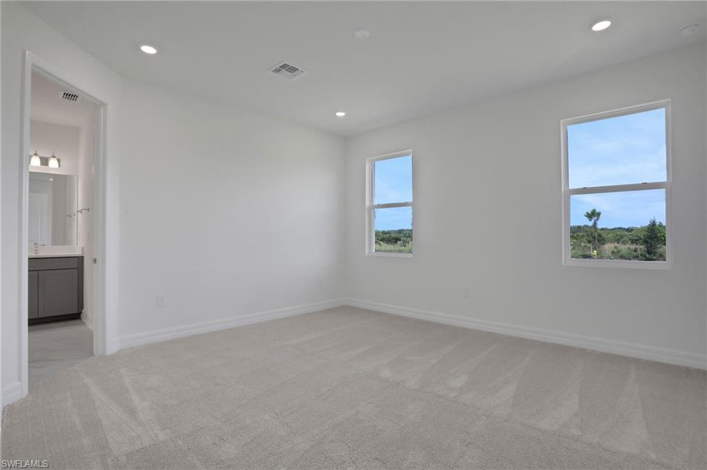 Spare room with light colored carpet and recessed lighting