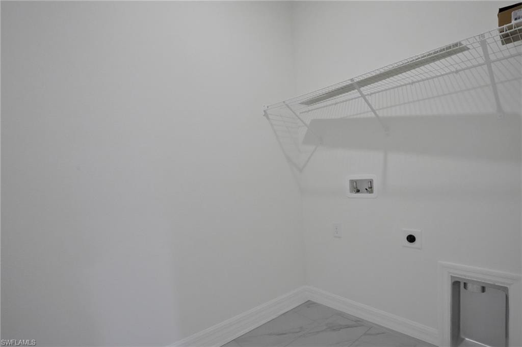 Laundry area with hookup for a washing machine, light marble finish flooring, and electric dryer hookup