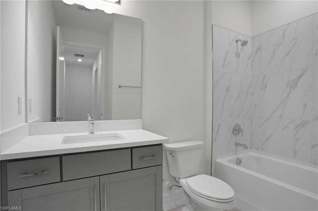 Full bathroom featuring washtub / shower combination and vanity
