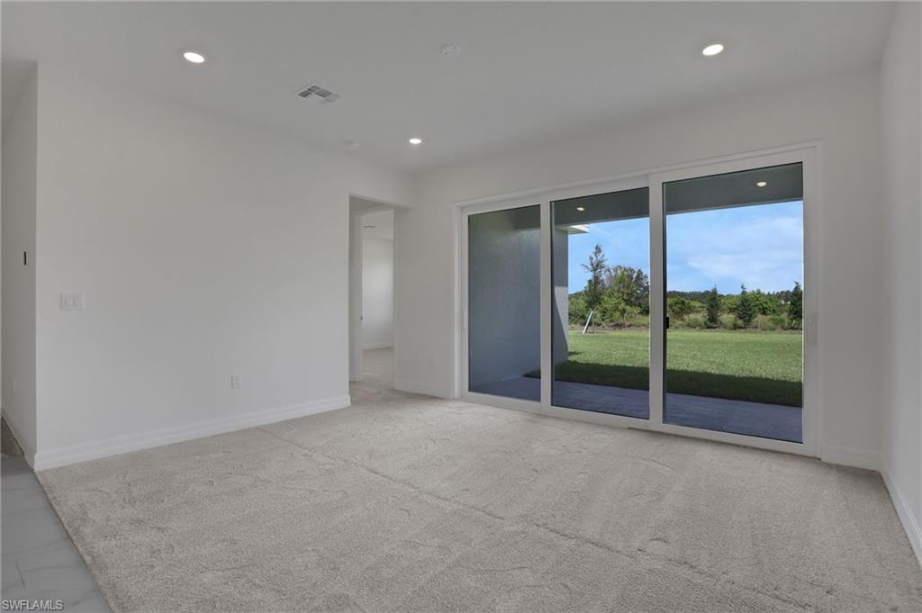 Spare room with recessed lighting and light carpet