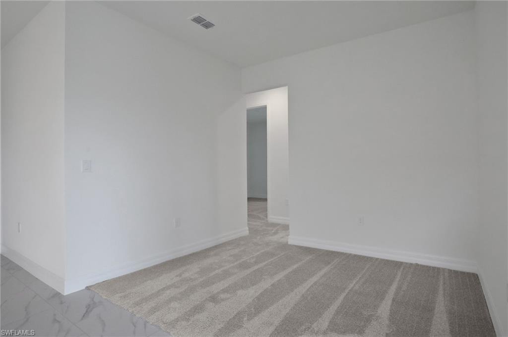 Unfurnished room with baseboards and light marble finish flooring
