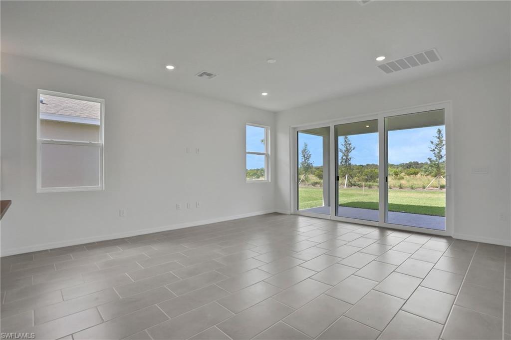 Unfurnished room featuring recessed lighting and light tile patterned floors