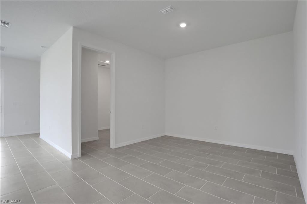 Unfurnished room with baseboards and recessed lighting