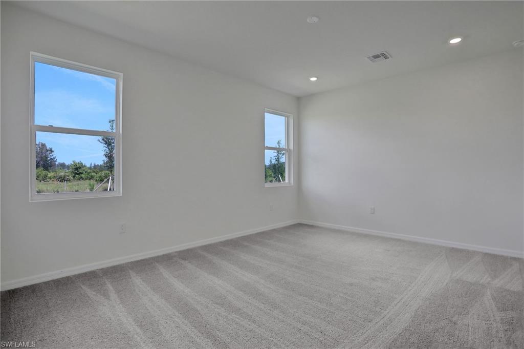 Spare room featuring light carpet and recessed lighting