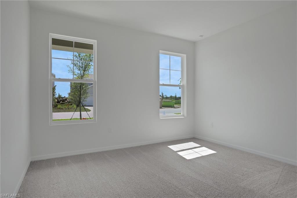 Unfurnished room featuring light colored carpet and baseboards