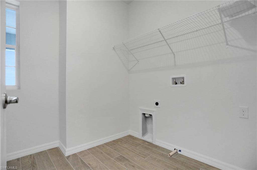 Laundry room with wood tiled floors, washer hookup, and electric dryer hookup