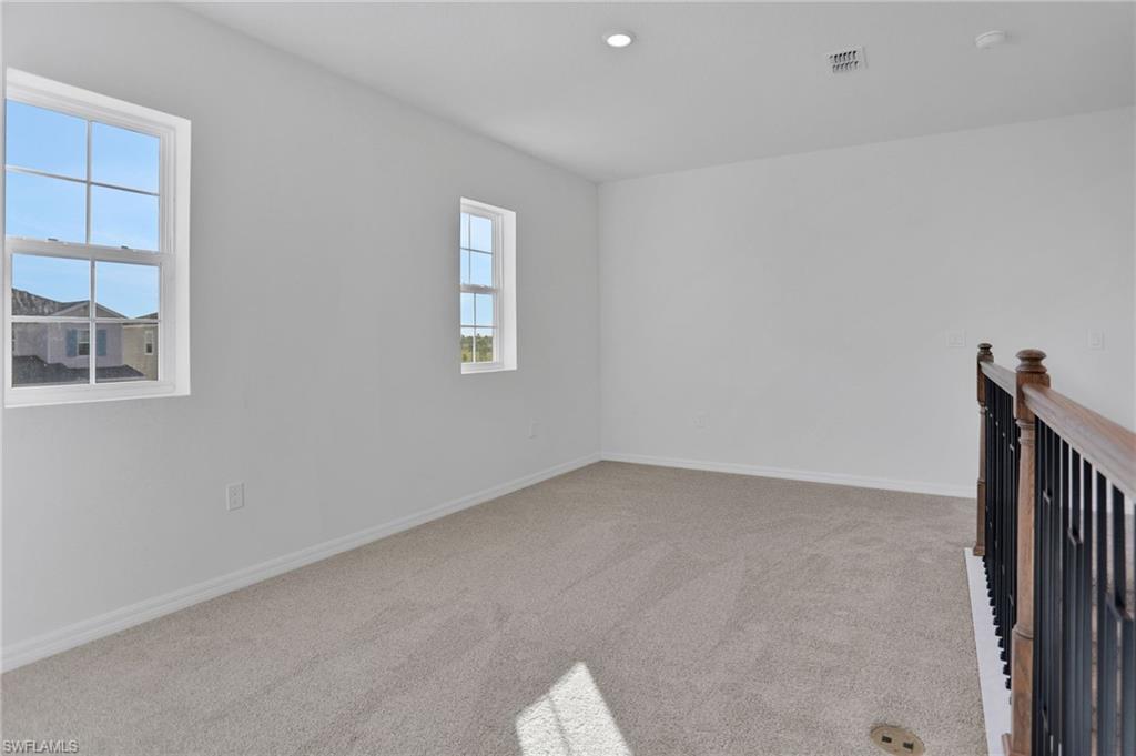 Spare room with light carpet and recessed lighting