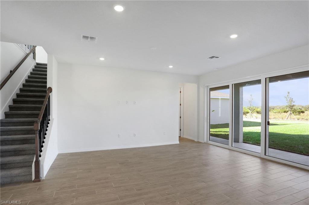 Unfurnished living room with recessed lighting and wood finish floors