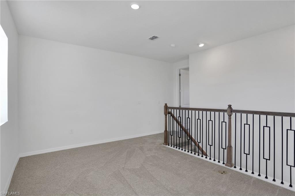 Empty room featuring carpet flooring and recessed lighting