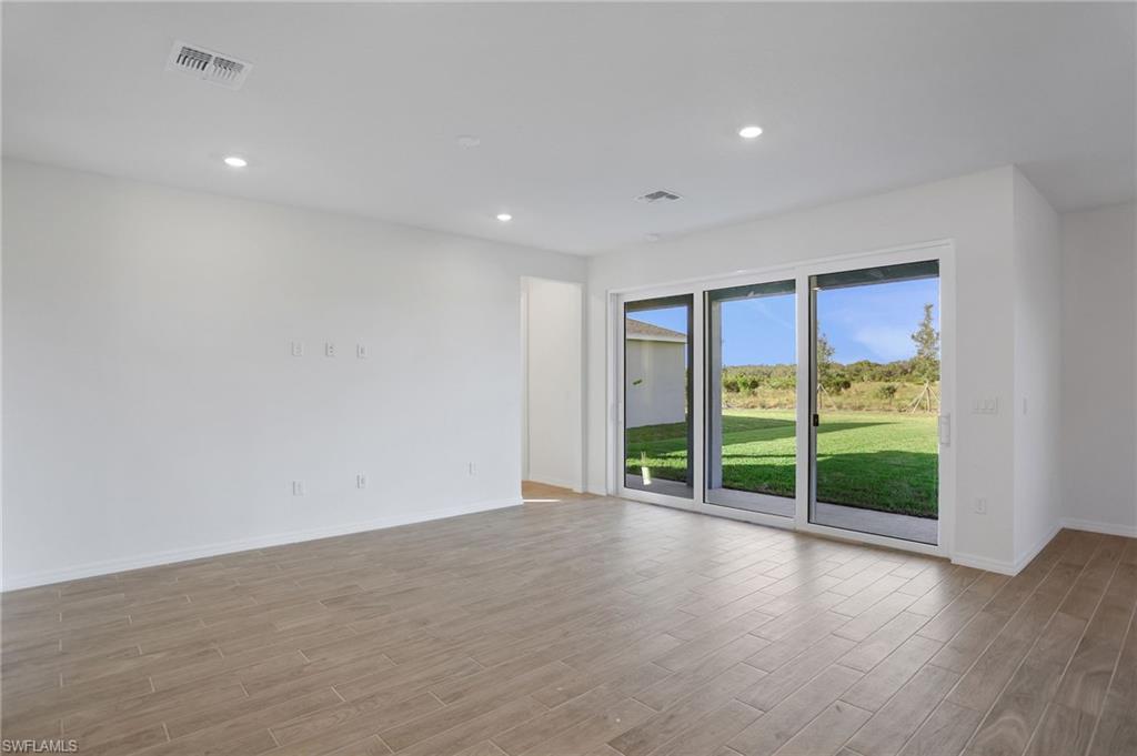 Spare room featuring light wood finished floors and recessed lighting