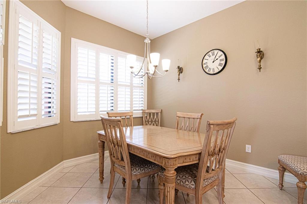 Dining room featuring light tile patterned floors and suspended lighting