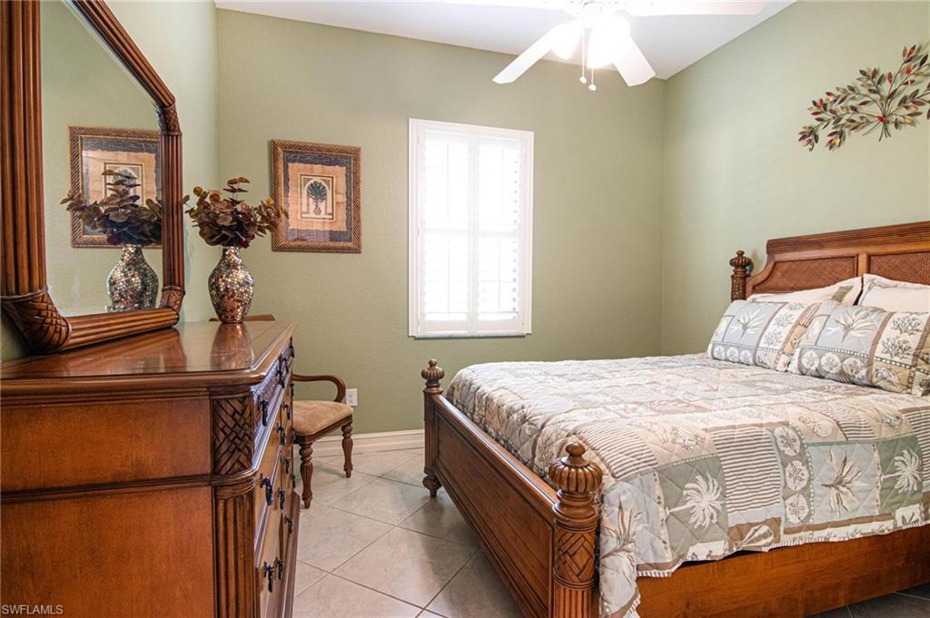 Bedroom featuring light tile patterned floors and ceiling fan